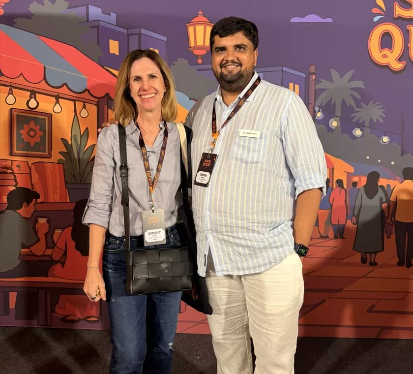 Kishan Mehta networking with a Shop Quest 2026 attendee